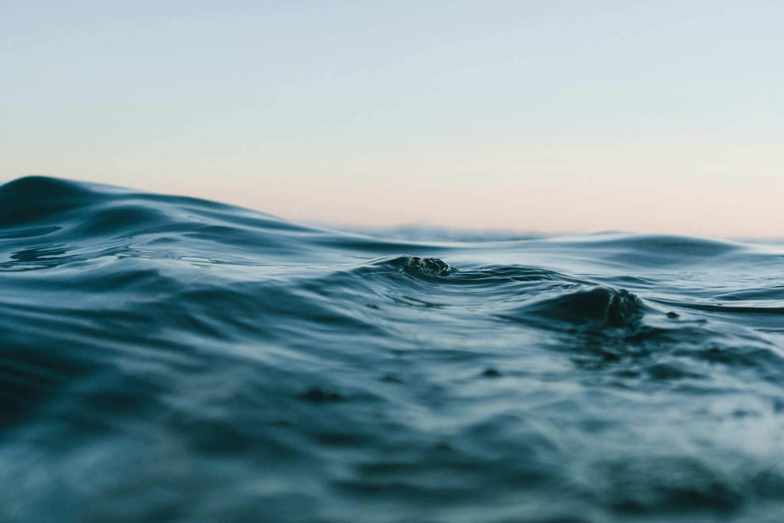 Deep blue-green ocean water at dusk (placeholder photo)